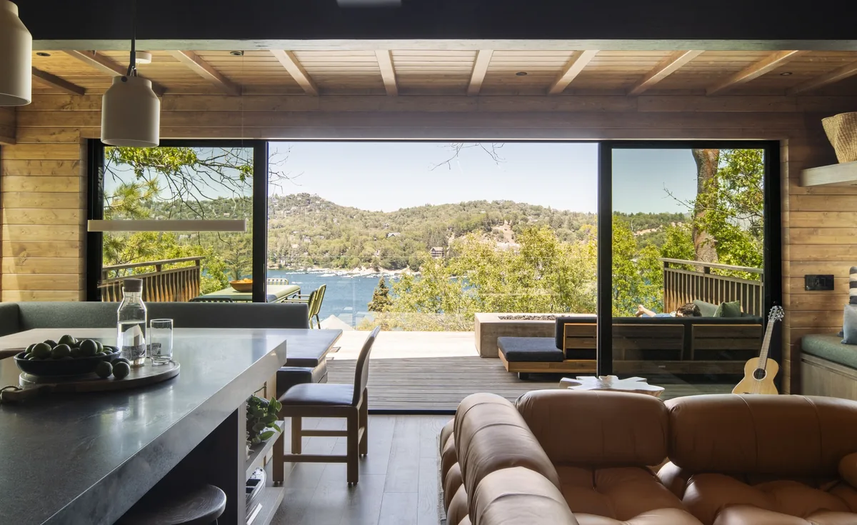 The great room at Little Doe Cabin, sliding doors open to a deck overlooking Lake Arrowhead